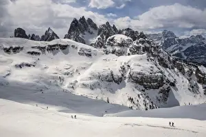 Remote Prints: Hikers along the path to Auronzo Refuge, in the background the mountain group of Cadini