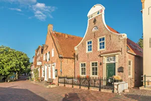 East Frisian Prints: Historic brick houses at the harbor in Greetsiel, East Frisia, Lower Saxony, Germany