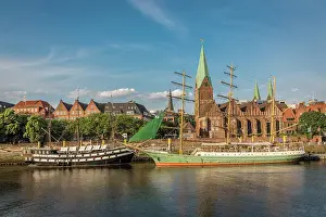 Historic sailing ships Admiral Nelson and Alexander von Humboldt at the Martini pier with St. Martini Church, Bremen, Germany