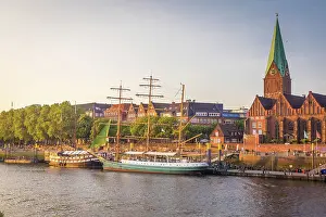 Historic sailing ships Admiral Nelson and Alexander von Humboldt at the Martini pier with St. Martini Church, Bremen, Germany