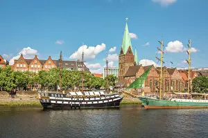Historic sailing ships Admiral Nelson and Alexander von Humboldt at the Martini pier with St. Martini Church, Bremen, Germany