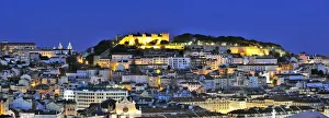 The historical centre and the Sao Jorge castle at dusk. Lisbon, Portugal