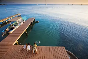 Honduras Prints: Honduras, Bay Islands, Utila, Children play on Jetty outside Cafe Mariposa