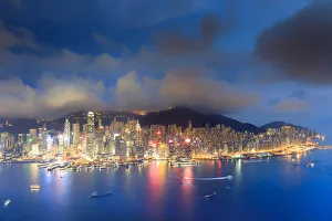 Images Dated 10th March 2017: Hong Kong, city overview by night with Victoria harbour and peak in the background