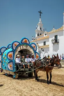 Rocio Prints: Horse-drawn carriage with pilgrims during the brotherhood parade of El Rocio pilgrimage