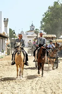 Rocio Prints: Horsemen riding in a street during the Romeria de El Rocio pilgrimage