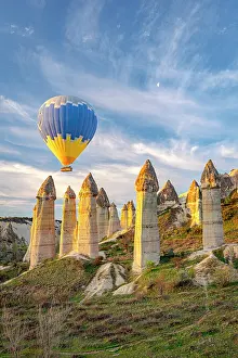 Hot air balloon above fairy chimneys, Love Valley, Goreme National Park, Cappadocia, Central Anatolia, Turkey