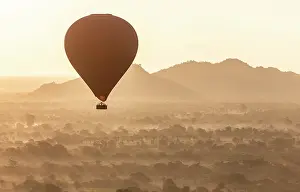 Mandalay Region Prints: Hot air balloon flying over the valley at dawn