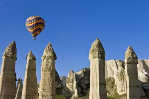 Images Dated 10th July 2008: Hot Air balloon over the Phallic pillars (Fairy Chimneys), Love Valley, near Goreme