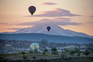 Images Dated 26th July 2022: Hot air balloons at dawn in front of Mount Erciyes, Goreme, Cappadocia, Nevsehir Province