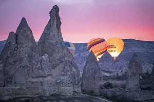 Kapadokya Prints: Hot Air Balloons rising at sunrise in Rose Valley, Cappadocia, Turkey