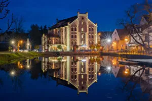Hotel Budweis reflecting in Malse river at twilight, Ceske Budejovice, South Bohemian Region, Czech Republic