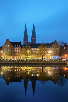 Gable Gallery: Houses on riverfront of Trave river with towers of St. Marienkirche church in background at