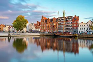 Lubeck Prints: Houses on riverside of Trave river and Wassertreppe (Water steps) at sunset