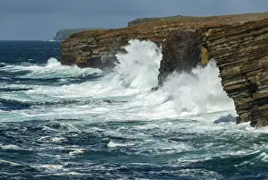 Huge waves crash against the layered cliffs of Yesnaby on the wild west coast of Mainland