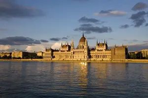 Hungary, Budapest. The Parliament Building by the River Danube, catches the last of the evening sun