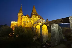 Hunyadi Castle or Corvins Castle illuminated at dusk, Hunedoara, Transylvania