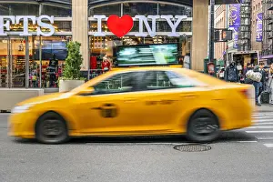 Taxi Prints: I Love New York gift shop sign and blurred yellow taxi cab passing, Times Square