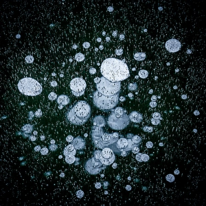 Pattern Prints: Ice bubbles trapped in lake Montespluga at night