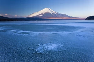 Ice on Lake Yamanaka with snowcovered Mount Fuji in background, Japan
