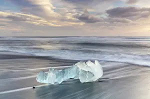 Iceberg Prints: Iceberg on the beach at sunrise, near Jokulsarlon glacial lagoon, Iceland