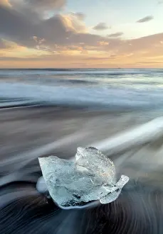 Iceberg Prints: Iceberg on the beach at sunrise, near Jokulsarlon glacial lagoon, Iceland