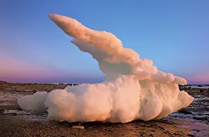 Iceberg stranded on the coastal shoreline of Hudson Bay at sunset. Hudson Bay Lowlands. Churchill, Manitoba, Canada