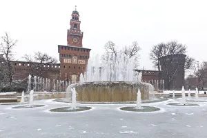 Sforzesco Castle Prints: A iced fountain and Sforzesco Castle after a snowfall. Milan, Lombardy, Northern Italy
