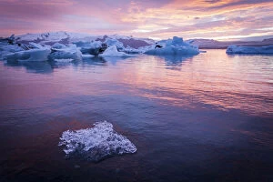 Iceland, Jokulsarlon Glacier Lagoon, icebergs and ice chunk at sunset
