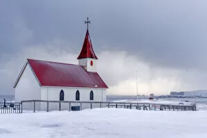 Iceland: the little church of Reynisfjara looking at the storm on the seashore