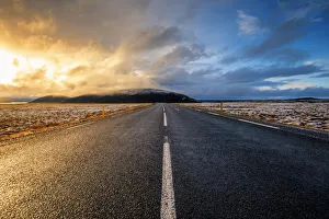 Dramatic Sky Prints: Iceland, Northern Europe. A paved road with dramatic sky