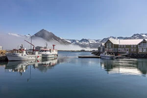 Iceland, SiglufjAA┬ÂrAA┬░ur, Siglofjord, Siglo hotel and fishing boats in morning mist