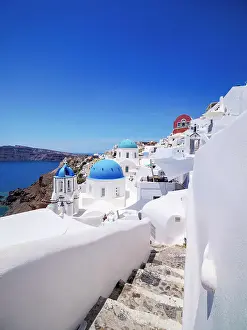 Iconic blue domed churches of Saint Spyridon and Resurrection of the Lord, Oia Village, Santorini or Thira Island, Cyclades, Greece