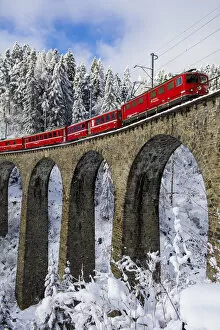 Images Dated 10th April 2015: Iconic swiss red Bernina Express train in winter landscape and pristine snow. Swizerland