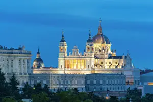 Baroque Style Prints: Illuminated Almudena Cathedral seen from Principe Pio at twilight, Madrid, Spain