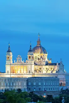 Baroque Style Prints: Illuminated Almudena Cathedral seen from Principe Pio at twilight, Madrid, Spain