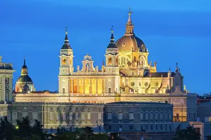 Baroque Style Prints: Illuminated Almudena Cathedral seen from Principe Pio at twilight, Madrid, Spain