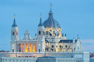 Illumination Prints: Illuminated Almudena Cathedral seen from Principe Pio at twilight, Madrid, Spain