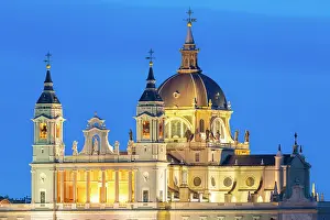 Baroque Style Prints: Illuminated Almudena Cathedral seen from Principe Pio at twilight, Madrid, Spain