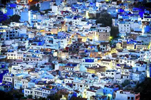 Rooftop Prints: Illuminated crowded blue houses of Chefchaouen viewed from a hill at night, Morocco
