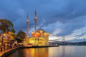 Turkiye Prints: Illuminated Grand Mecidiye Mosque (Ortakoy Mosque) with Bosphorus Bridge in background at twilight