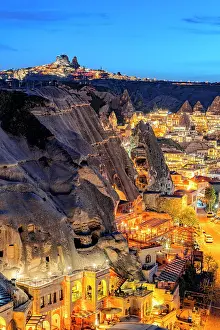 Uchisar Prints: Illuminated houses in Goreme and Uchisar at dusk