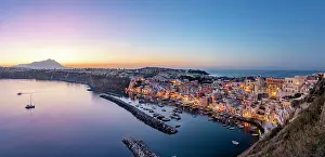 Naples Province Prints: Illuminated houses of La Corricella fishing village and harbor at blue hour