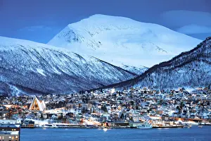 Majestic Prints: Illuminated houses with snowy mountains overlooking the fjord, Tromso, Norway