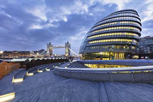 Illuminated Tower Bridge, City Hall, right, designed by Norman Foster, at dawn, London