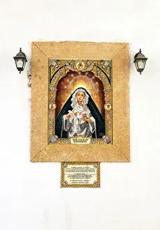 Saint Prints: Image of Maria Santisima de los Desamparados (Virgin of the Helpless) on a building facade in Cadiz