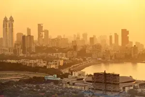 Bombay Prints: India, Maharashtra, Mumbai, sunset over the city centre and Haji Ali Bay showing