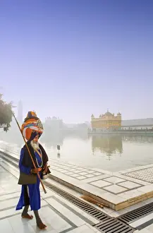 Sikhism Prints: India, Punjab, Amritsar, a sikh pilgrim carrying a barcha spear at the Golden Temple