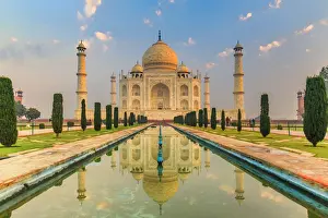 India, Taj Mahal mausoleum in the early morning reflecting in the water pool