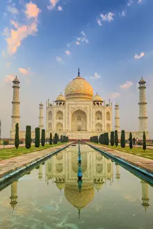 India, Taj Mahal mausoleum in the early morning reflecting in the water pool